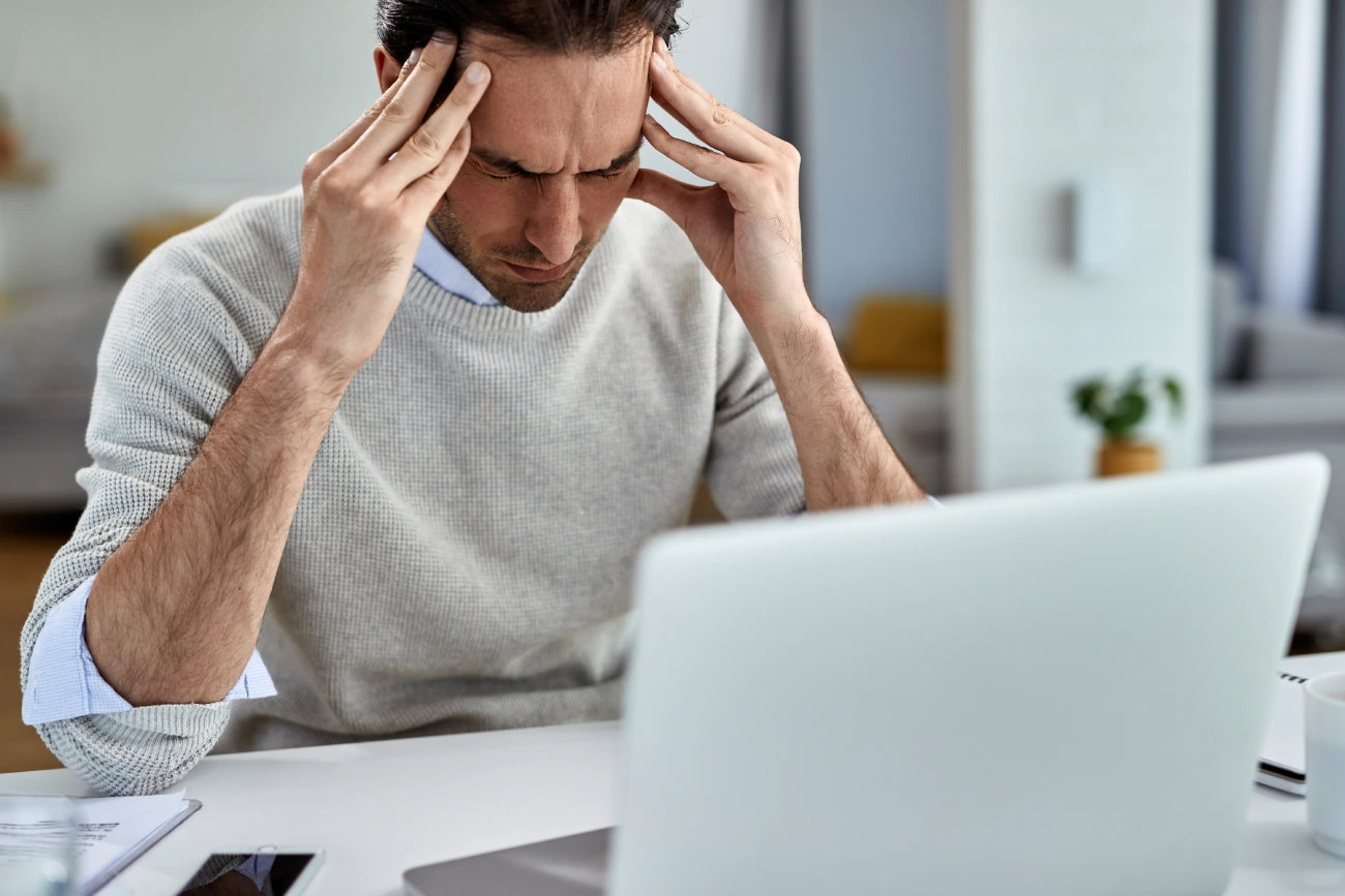 exhausted-entrepreneur-holding-his-head-pain-after-working-computer-home exhausted-entrepreneur-holding-his-head-pain-after-working-computer-home