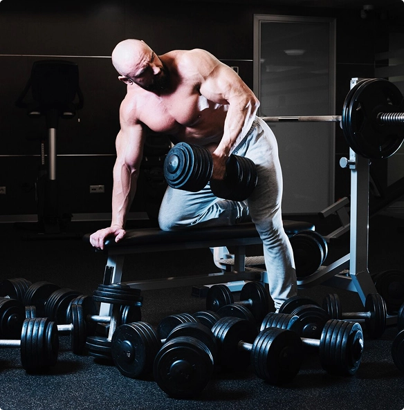 A man on the sidewalk grips a resistance band, ready to begin his exercise routine.
