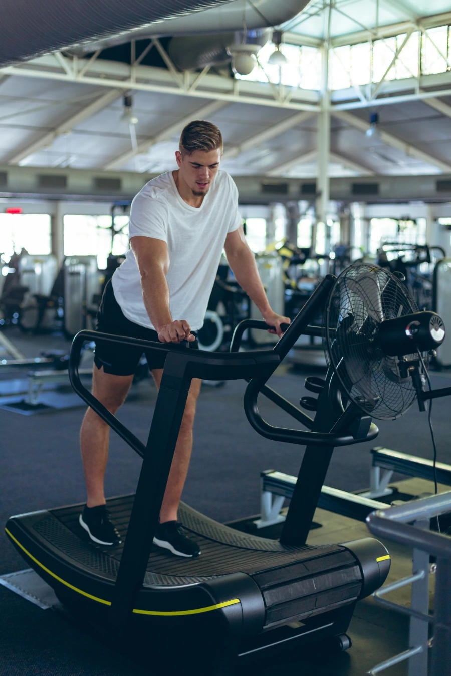tired-male athlete standing treadmill fitness